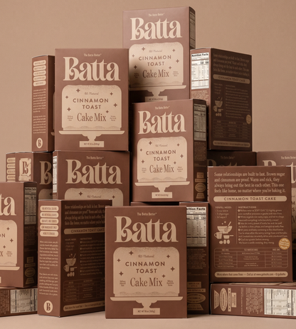 Stack of Batta Cinnamon Toast Cake Mix boxes on a beige background. Batta all-natural cake and frosting mixes - gourmet gifts for bakers, moms, foodies