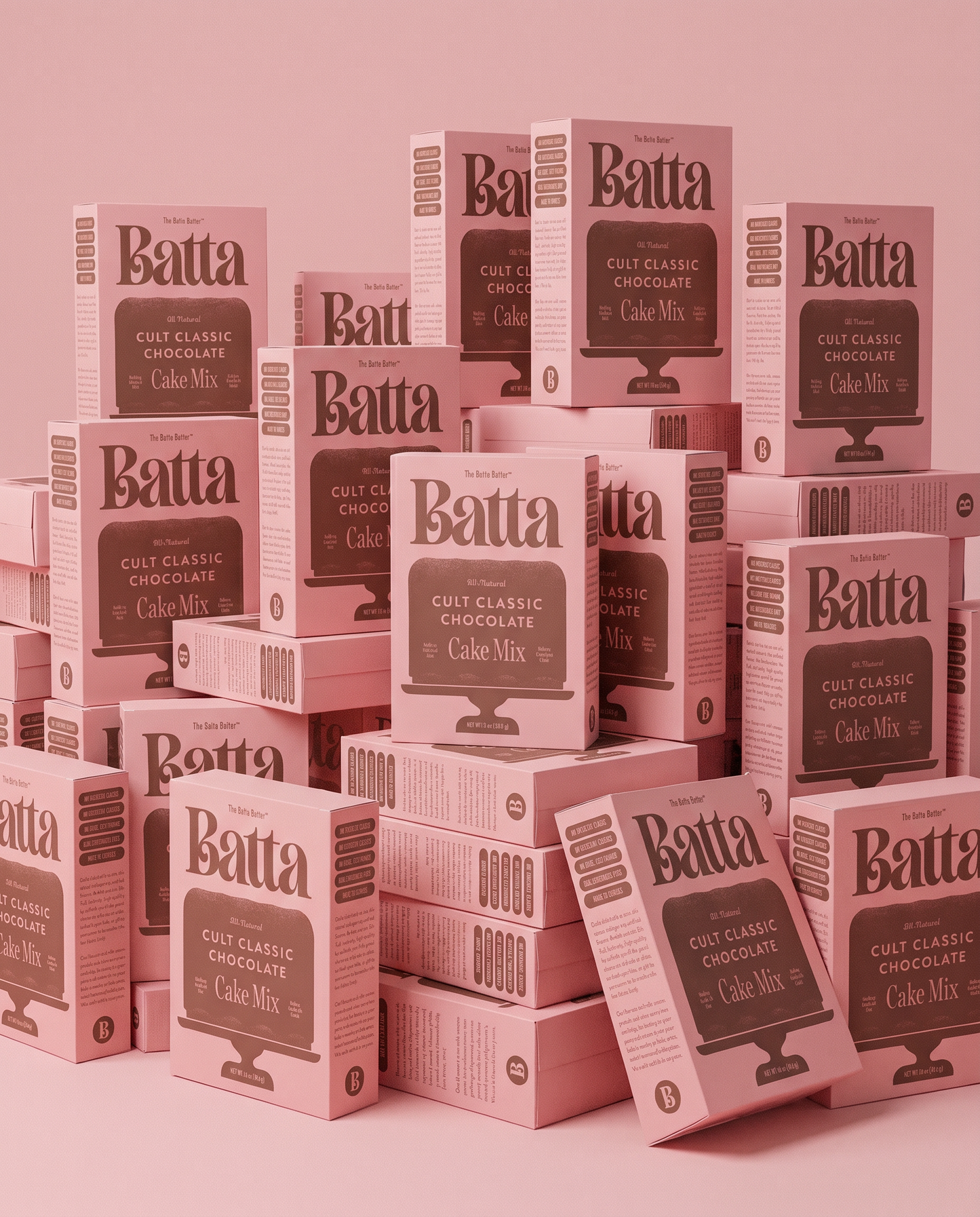 Batta all-natural cake and frosting mixes - gourmet gifts for bakers, moms, foodies. Stack of pink Cult Classic Chocolate cake mix boxes on pink background.