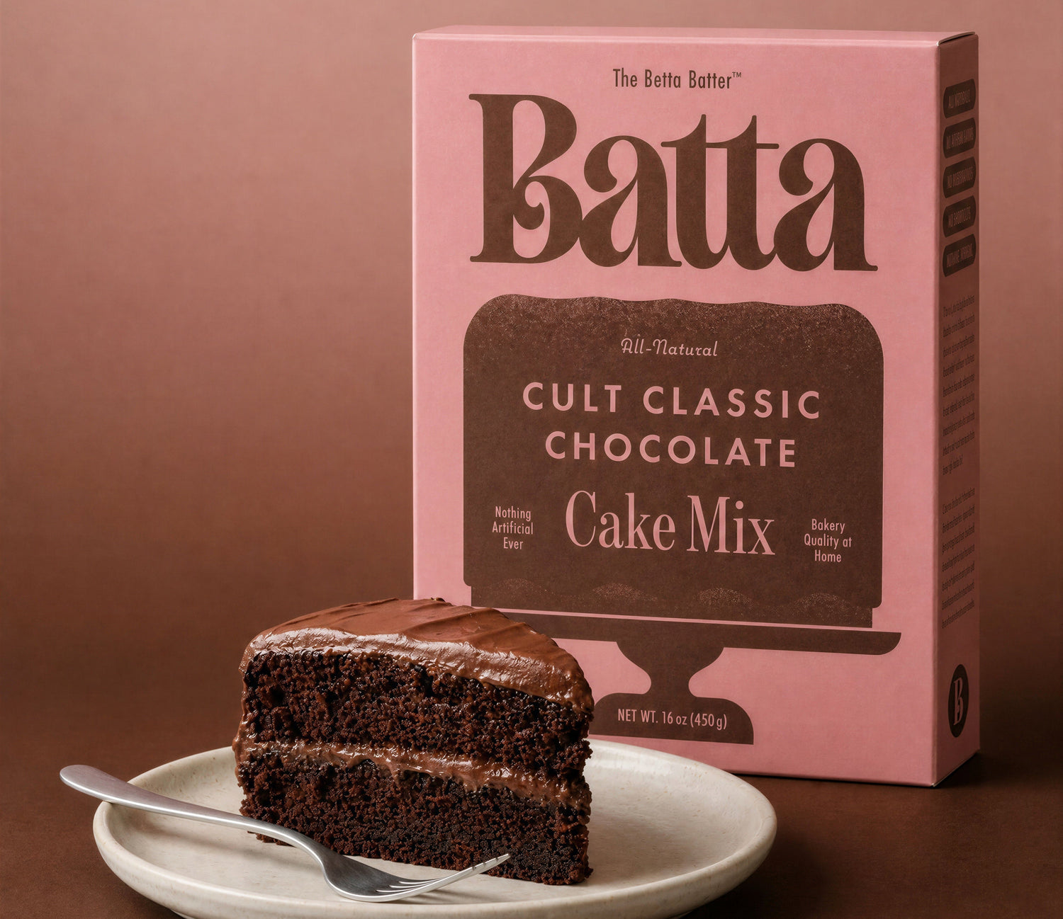 Batta Cult Classic Chocolate Cake Mix box with a slice of chocolate cake on a plate against a brown background
